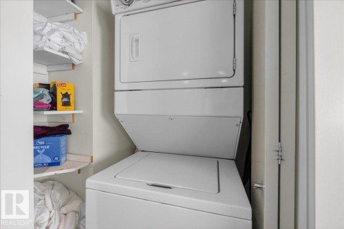 Laundry area featuring stacked washer and dryer - 301 2504 109 Street, Edmonton, AB - Indoor Photo Showing Laundry Room