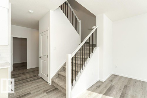Stairway with wood finished floors and baseboards - 3790 Wren Loop, Edmonton, AB - Indoor Photo Showing Other Room