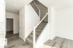 Stairway with wood finished floors and baseboards - 
