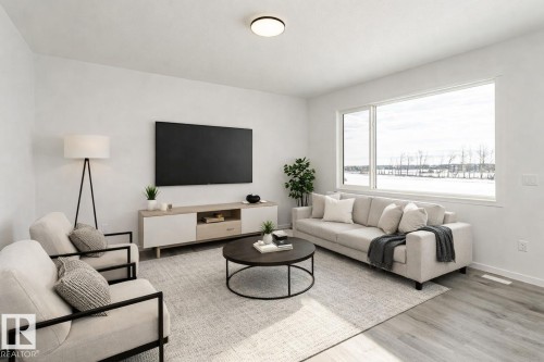 Living area featuring light wood-style flooring and baseboards - 3790 Wren Loop, Edmonton, AB - Indoor Photo Showing Living Room
