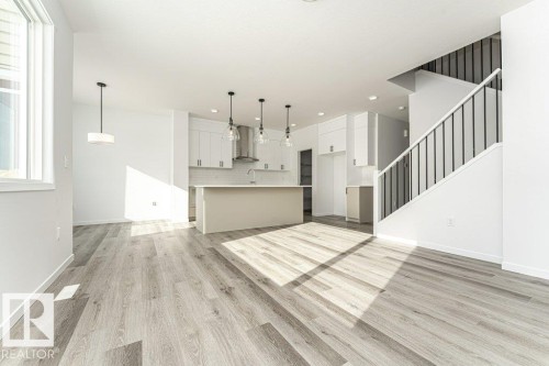 Unfurnished living room with light wood-style flooring and recessed lighting - 3790 Wren Loop, Edmonton, AB - Indoor