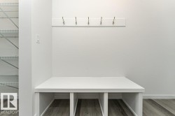 Mudroom featuring wood finished floors and baseboards - 