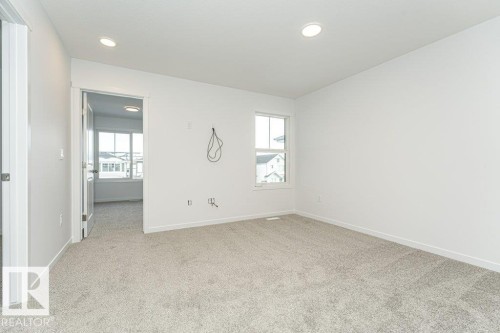 Spare room featuring plenty of natural light, light carpet, and recessed lighting - 3790 Wren Loop, Edmonton, AB - Indoor Photo Showing Other Room