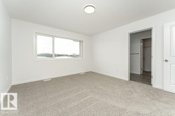 Unfurnished bedroom featuring carpet and baseboards - 