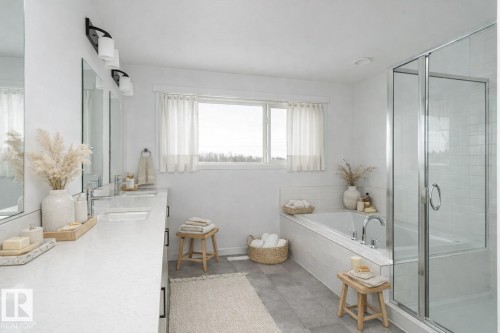 Full bath with double vanity, a bath, and a stall shower - 3790 Wren Loop, Edmonton, AB - Indoor Photo Showing Bathroom