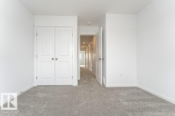 Unfurnished bedroom with carpet flooring and a closet - 