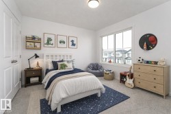 Bedroom featuring light carpet and baseboards - 