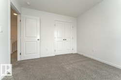 Unfurnished bedroom with dark colored carpet and a closet - 