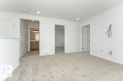 Unfurnished bedroom with ensuite bath, recessed lighting, and light colored carpet - 