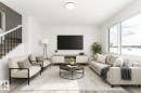 Living area featuring light wood-type flooring and stairs - 3790 Wren Loop, Edmonton, AB  - Indoor Photo Showing Living Room 