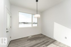 Unfurnished dining area featuring light wood finished floors and baseboards - 