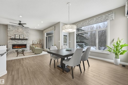 1130 Twin Brooks Point(E), Edmonton, AB - Indoor Photo Showing Dining Room With Fireplace