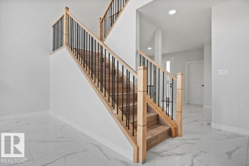 Staircase featuring marble finish floors and recessed lighting - 3912 41 Avenue, Beaumont, AB - Indoor Photo Showing Other Room