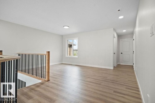 Unfurnished room with light wood-style flooring, a textured ceiling, and recessed lighting - 3912 41 Avenue, Beaumont, AB - Indoor Photo Showing Other Room