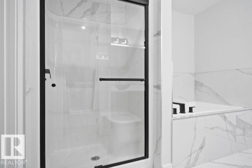 Bathroom with a marble finish shower and a garden tub - 3912 41 Avenue, Beaumont, AB - Indoor Photo Showing Bathroom