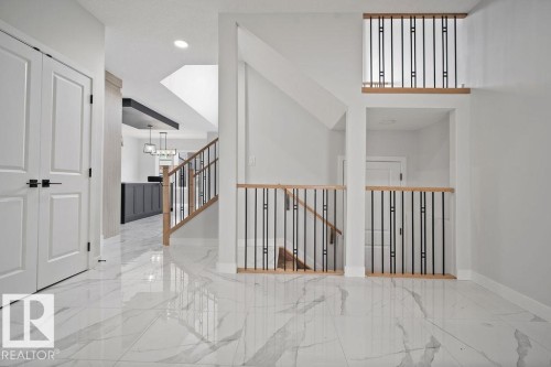 Hall with light marble finish flooring - 3912 41 Avenue, Beaumont, AB - Indoor Photo Showing Other Room