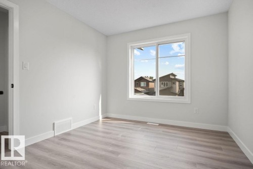 Unfurnished room with light wood-type flooring and baseboards - 3912 41 Avenue, Beaumont, AB - Indoor Photo Showing Other Room