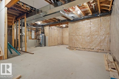 Unfinished basement with gas water heater and heating unit - 3912 41 Avenue, Beaumont, AB - Indoor Photo Showing Basement