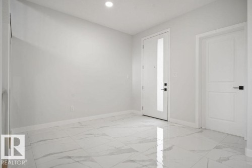 Foyer with light marble finish floors and recessed lighting - 3912 41 Avenue, Beaumont, AB - Indoor Photo Showing Other Room
