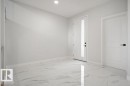 Foyer with light marble finish floors and recessed lighting - 3912 41 Avenue, Beaumont, AB  - Indoor Photo Showing Other Room 