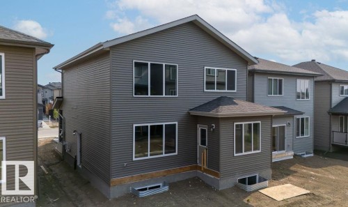 Back of property with a residential view and roof with shingles - 3912 41 Avenue, Beaumont, AB - Outdoor With Exterior
