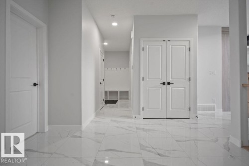Corridor featuring recessed lighting and light marble finish flooring - 3912 41 Avenue, Beaumont, AB - Indoor Photo Showing Other Room