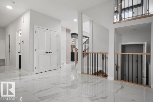 Hall with light marble finish floors and baseboards - 3912 41 Avenue, Beaumont, AB - Indoor Photo Showing Other Room