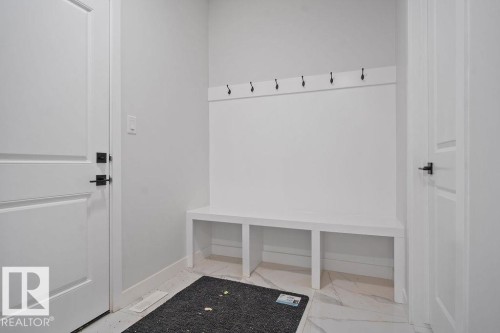 Mudroom featuring baseboards and light marble finish floors - 3912 41 Avenue, Beaumont, AB - Indoor Photo Showing Other Room