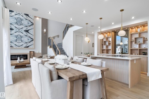 Dining room with a glass covered fireplace, recessed lighting, and light wood-style flooring - 13152 187 Avenue, Edmonton, AB - Indoor