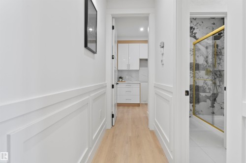 Corridor with light wood-type flooring, wainscoting, a decorative wall, and recessed lighting - 13152 187 Avenue, Edmonton, AB - Indoor Photo Showing Other Room