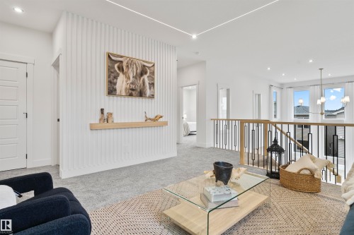 Living area with a chandelier and light carpet - 13152 187 Avenue, Edmonton, AB - Indoor Photo Showing Other Room