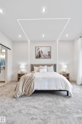 Bedroom featuring light colored carpet, a barn door, and recessed lighting - 13152 187 Avenue, Edmonton, AB - Indoor Photo Showing Bedroom