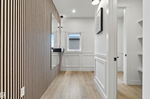 Hallway featuring wainscoting, light wood-style flooring, a decorative wall, and recessed lighting - 13152 187 Avenue, Edmonton, AB - Indoor Photo Showing Other Room