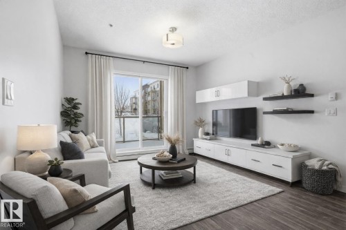 Virtually staged living room - 106 812 Welsh Drive, Edmonton, AB - Indoor Photo Showing Living Room