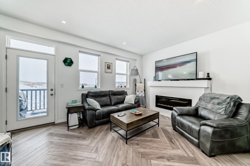 36 2072 Wonnacott Way, Edmonton, AB - Indoor Photo Showing Living Room With Fireplace