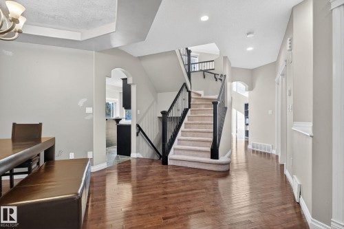 Foyer with arched walkways, dark wood-style flooring, and hanging lights - 613 Stewart Crescent, Edmonton, AB - Indoor Photo Showing Other Room