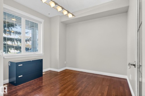 Empty room with dark wood-style floors and baseboards - 613 Stewart Crescent, Edmonton, AB - Indoor Photo Showing Other Room