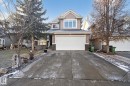 View of front facade with stone siding, driveway, and an attached garage - 613 Stewart Crescent, Edmonton, AB  - Outdoor With Facade 