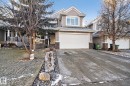 Craftsman inspired home with stone siding, a garage, driveway, roof with shingles, and covered porch - 613 Stewart Crescent, Edmonton, AB  - Outdoor With Facade 