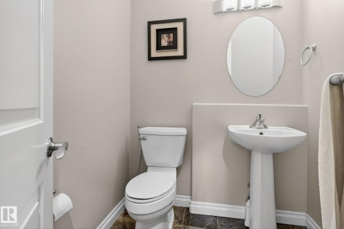 Half bath with baseboards and toilet - 613 Stewart Crescent, Edmonton, AB - Indoor Photo Showing Bathroom