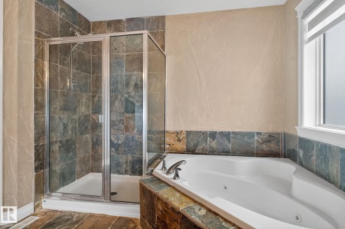 Bathroom with a shower stall and a jetted tub - 613 Stewart Crescent, Edmonton, AB - Indoor Photo Showing Bathroom