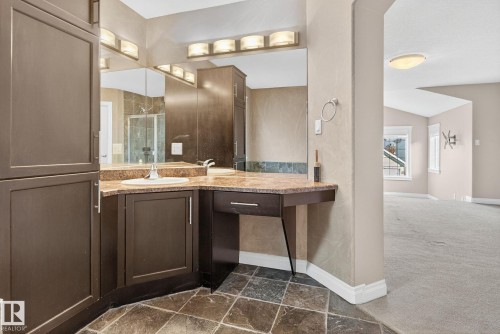 Bathroom featuring vanity, dark colored carpet, a stall shower, and vaulted ceiling - 613 Stewart Crescent, Edmonton, AB - Indoor Photo Showing Bathroom