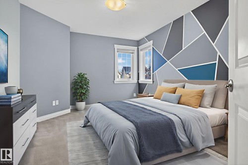 Bedroom featuring an accent wall and light carpet - 613 Stewart Crescent, Edmonton, AB - Indoor Photo Showing Bedroom