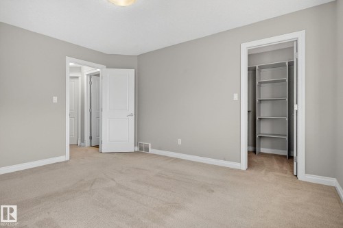 Unfurnished bedroom with a spacious closet and light carpet - 613 Stewart Crescent, Edmonton, AB - Indoor Photo Showing Other Room