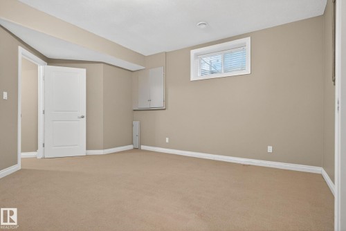Below grade area featuring light carpet and baseboards - 613 Stewart Crescent, Edmonton, AB - Indoor Photo Showing Other Room