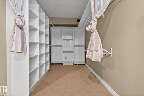 Walk in closet with light carpet - 613 Stewart Crescent, Edmonton, AB - Indoor With Storage