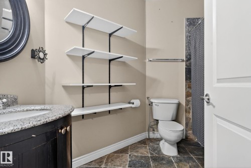 Full bath with vanity, a shower, and dark stone finish floors - 613 Stewart Crescent, Edmonton, AB - Indoor Photo Showing Bathroom