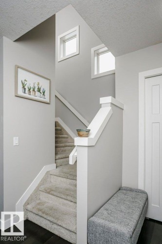 Stairway featuring a textured ceiling and wood finished floors - 6710 Cardinal Road, Edmonton, AB - Indoor Photo Showing Other Room