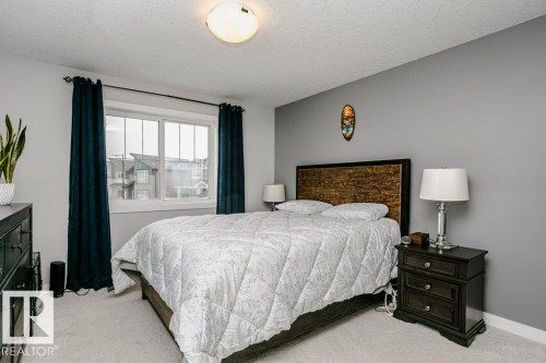 Bedroom featuring a textured ceiling and light colored carpet - 6710 Cardinal Road, Edmonton, AB - Indoor Photo Showing Bedroom