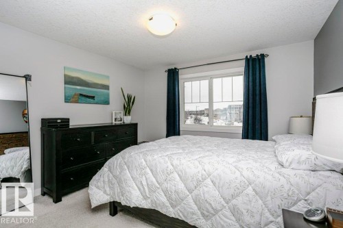 Bedroom with a textured ceiling and light carpet - 6710 Cardinal Road, Edmonton, AB - Indoor Photo Showing Bedroom